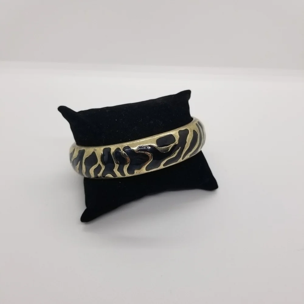 gold tone bangle with abstract black enamel pattern